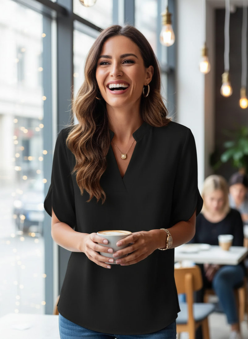 Woman holding a coffee cup in a casual setting