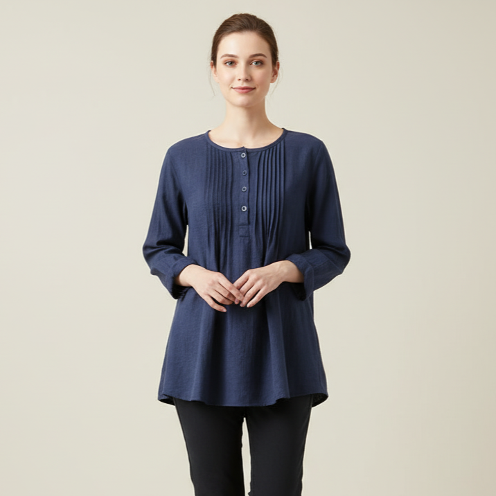 Woman wearing a navy blue top and black pants on a beige background