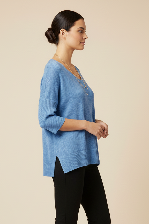 Woman wearing a blue top and black pants on a beige background